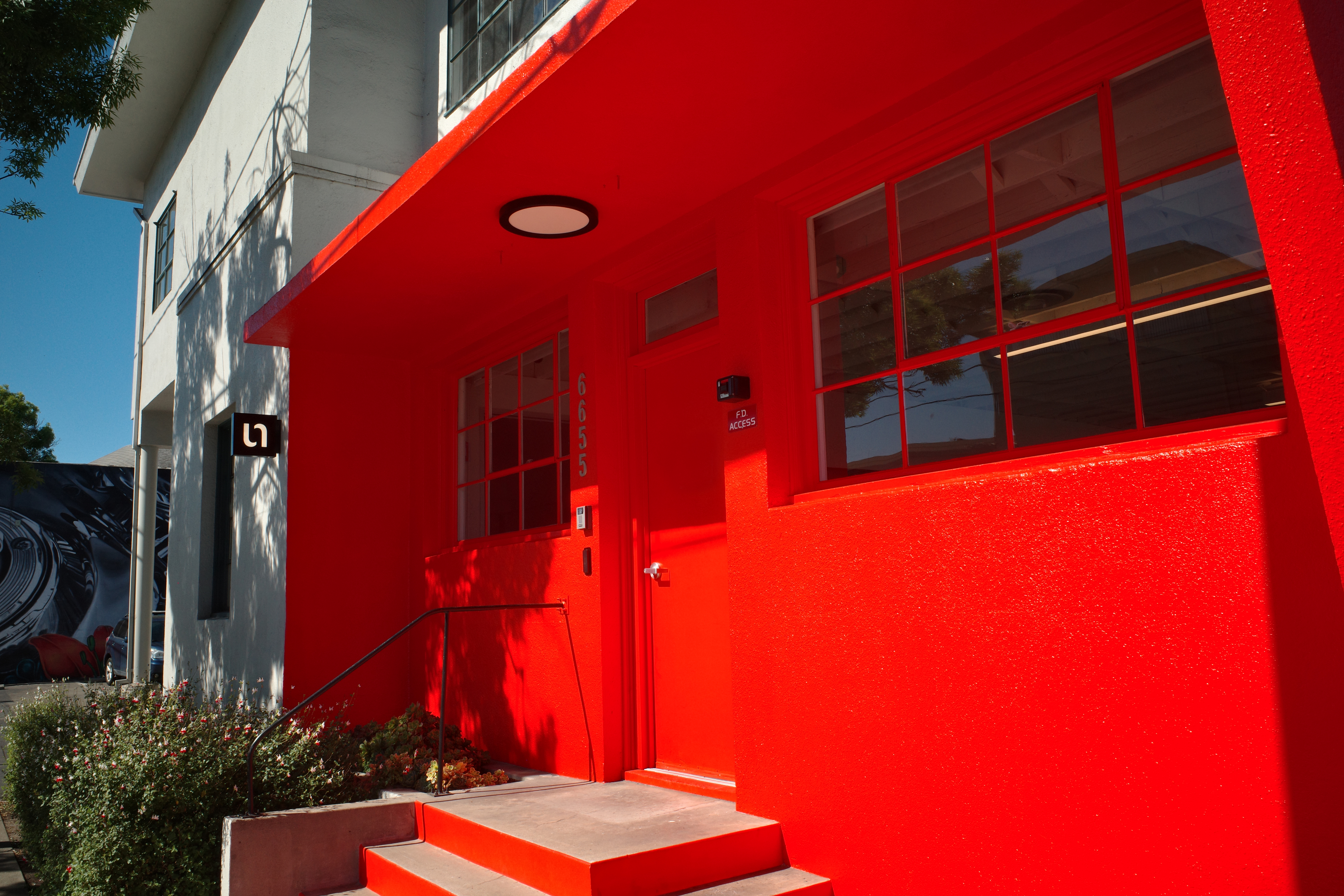 Woman in white dress and gold earrings walking down runway