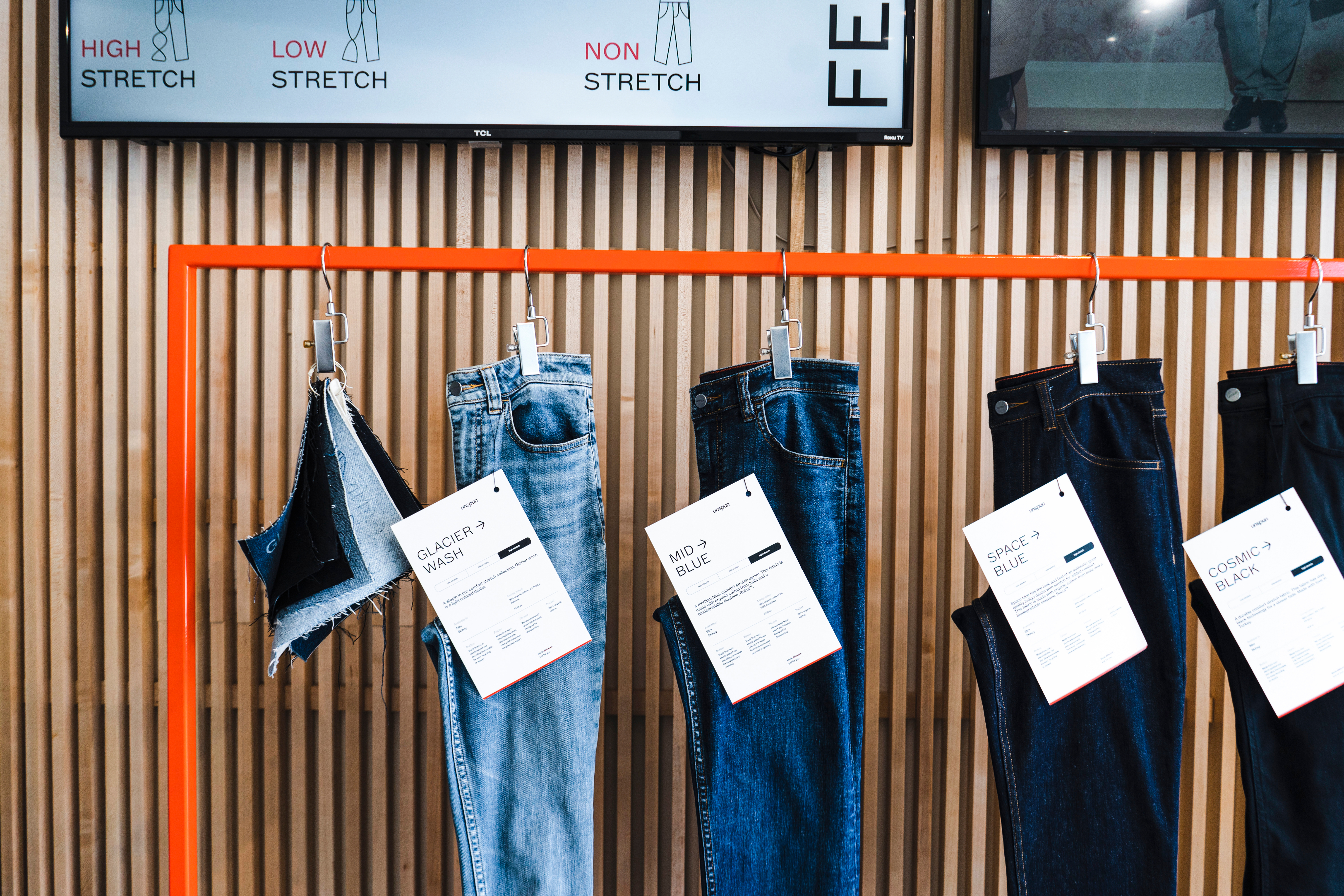 Woman in white dress and gold earrings walking down runway