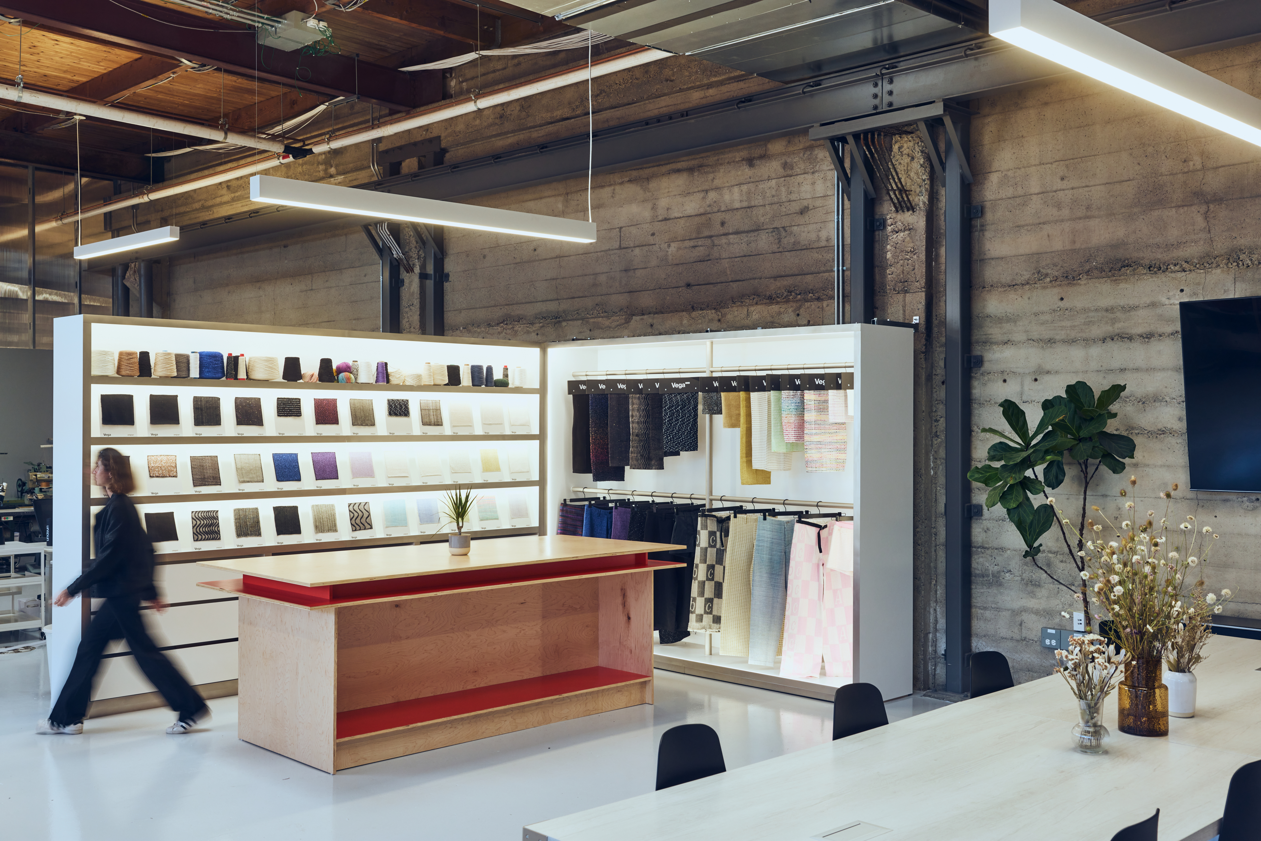 Woman in white dress and bucket hat walking down runway