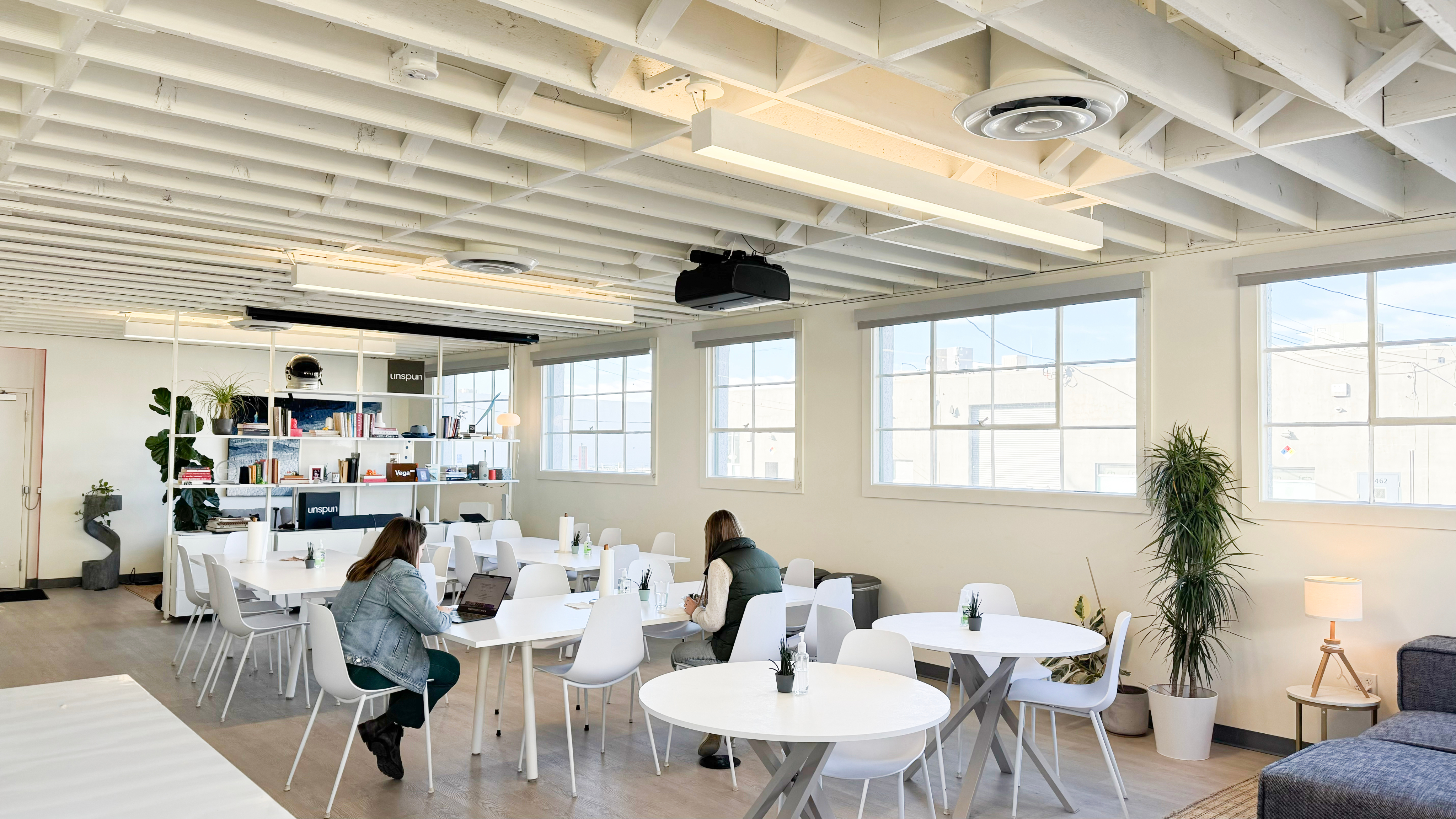 Woman in knee-length print dress walking down runway